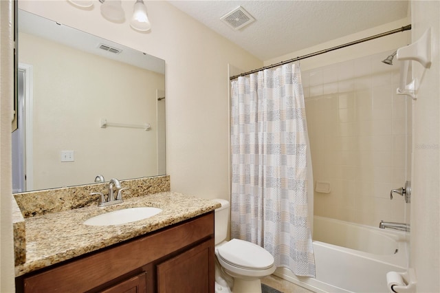 full bathroom featuring a textured ceiling, shower / tub combo, vanity, and toilet