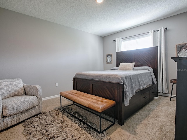 carpeted bedroom featuring a textured ceiling