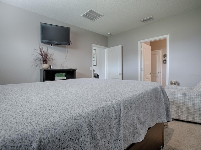 bedroom featuring a textured ceiling and carpet floors