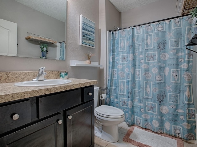 bathroom featuring vanity, tile patterned floors, a shower with curtain, toilet, and a textured ceiling