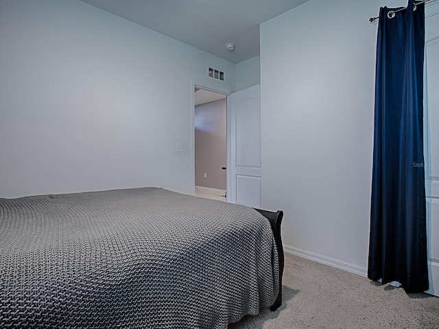 bedroom with light colored carpet