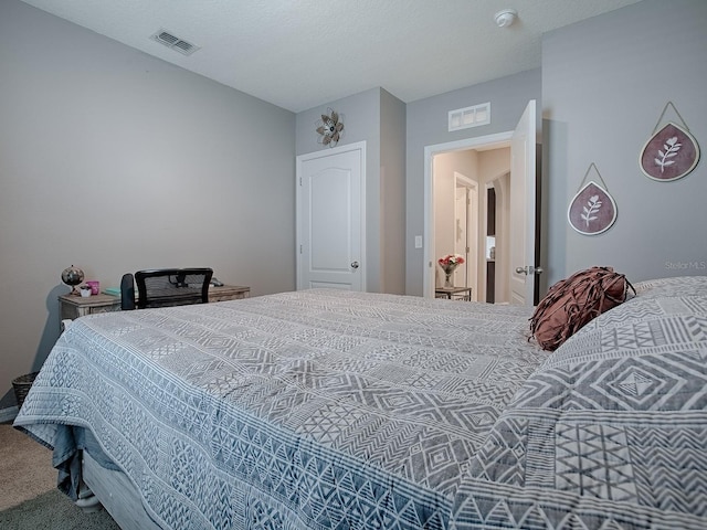 carpeted bedroom featuring a textured ceiling