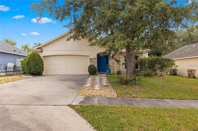 view of front of property with a garage and a front lawn