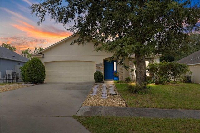 view of front facade with a yard and a garage