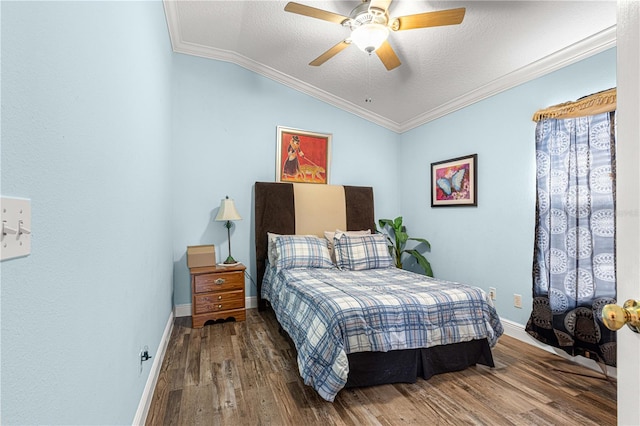 bedroom featuring ornamental molding, vaulted ceiling, ceiling fan, and hardwood / wood-style flooring