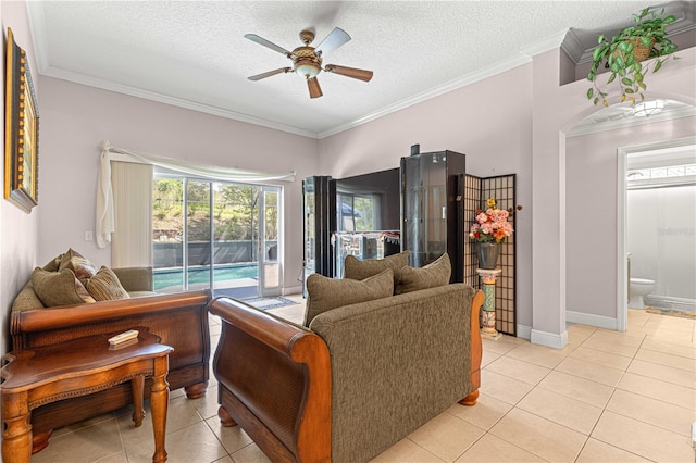 living room with ornamental molding, ceiling fan, and a textured ceiling