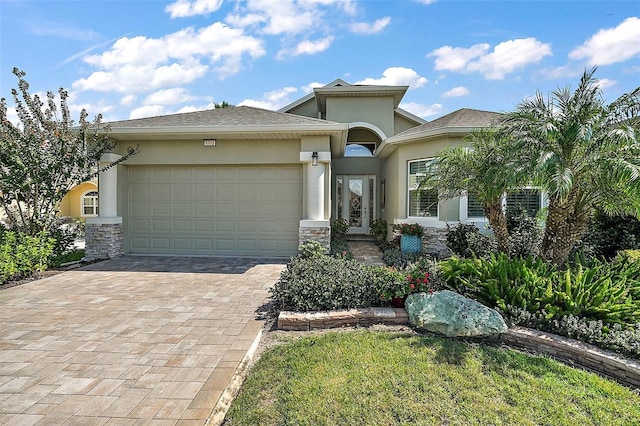 8732 Providence Ct, Mount Dora, FL 32757 - view of front facade with stone siding, stucco siding, decorative driveway, and an attached garage