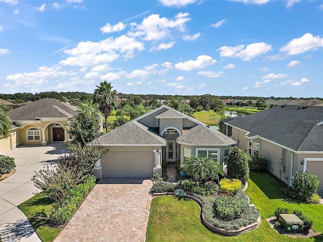 view of front of house with a front lawn and a garage