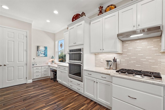 kitchen with decorative backsplash, white cabinetry, stainless steel appliances, and ornamental molding