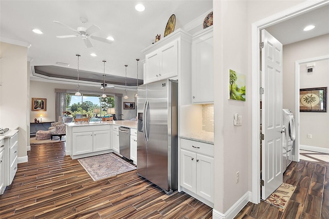 kitchen with pendant lighting, white cabinets, ceiling fan, appliances with stainless steel finishes, and kitchen peninsula