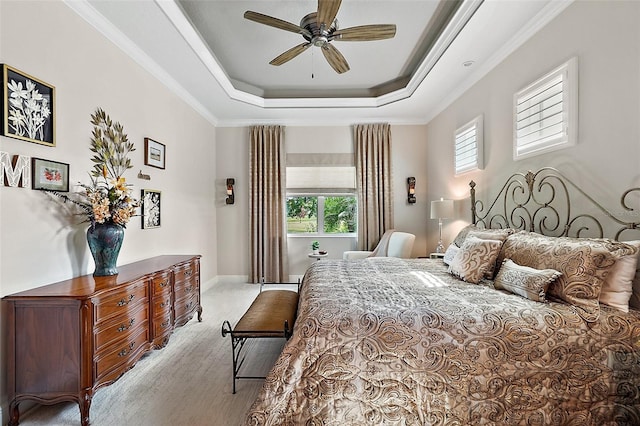 bedroom with a tray ceiling, ceiling fan, and crown molding