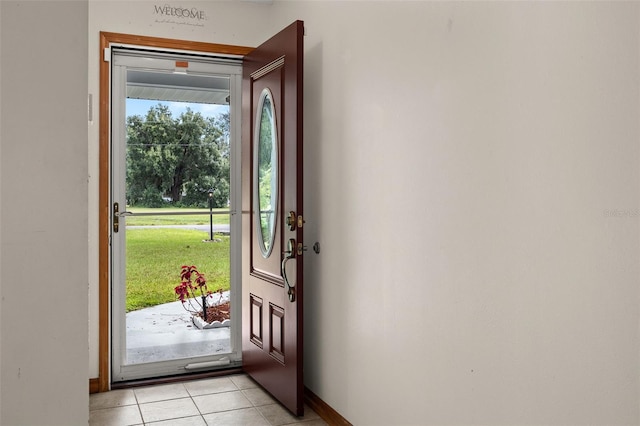 doorway with light tile patterned floors and a wealth of natural light