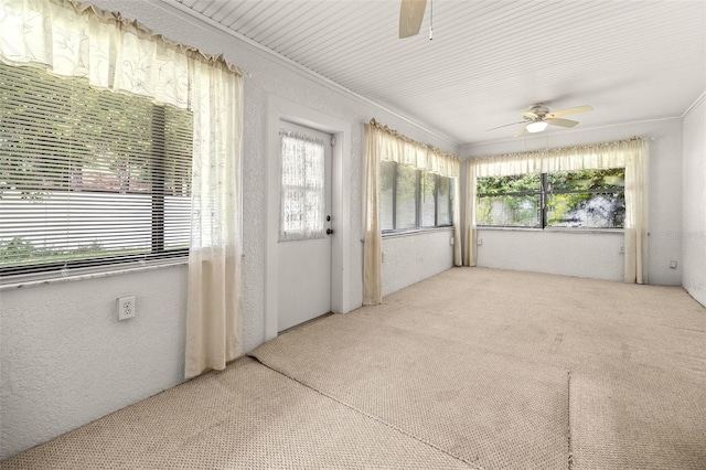 unfurnished sunroom featuring a healthy amount of sunlight and ceiling fan