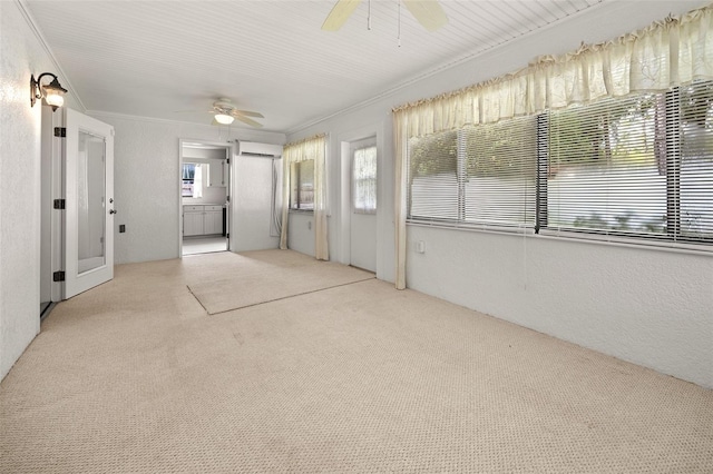 unfurnished sunroom with ceiling fan and a wall mounted AC