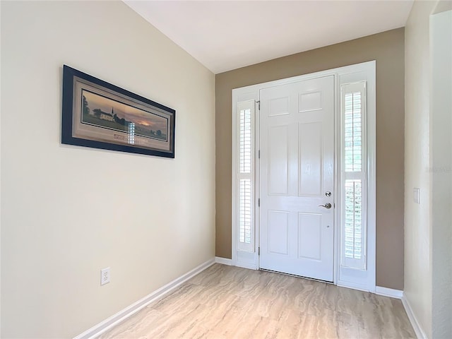 entrance foyer featuring light wood-type flooring and a healthy amount of sunlight