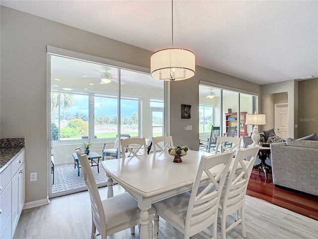 dining space with ceiling fan and light hardwood / wood-style floors