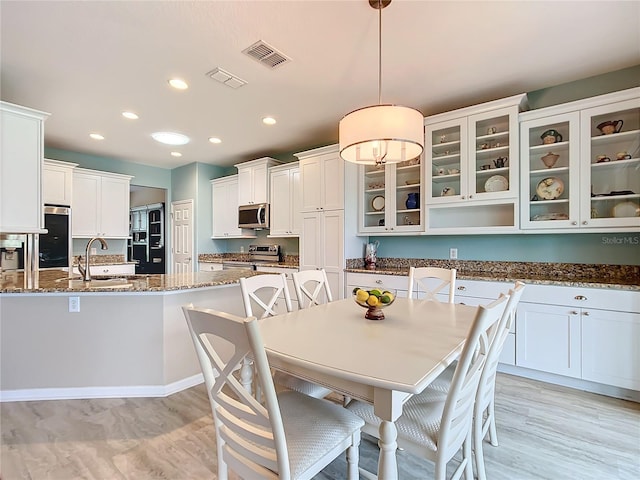 dining area featuring sink and light hardwood / wood-style floors