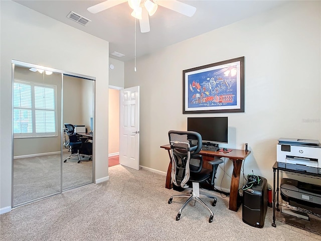 home office with ceiling fan and light carpet