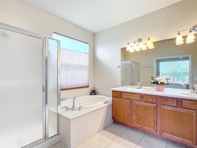 bathroom with tile patterned floors, independent shower and bath, and vanity