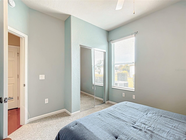 bedroom with ceiling fan, a closet, and carpet