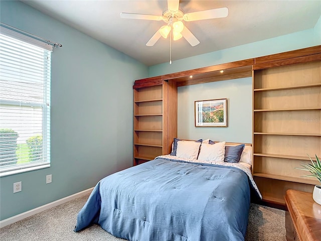 carpeted bedroom with multiple windows and ceiling fan