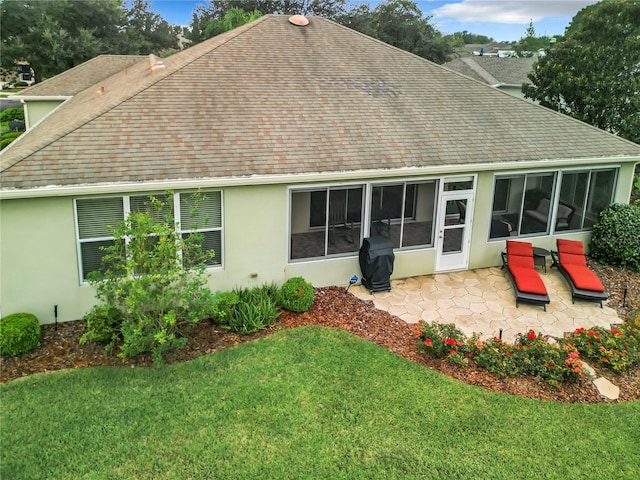 back of property featuring a lawn and a patio area