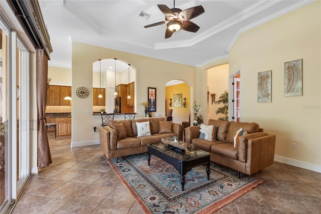 tiled living room with ornamental molding, ceiling fan, and a wealth of natural light