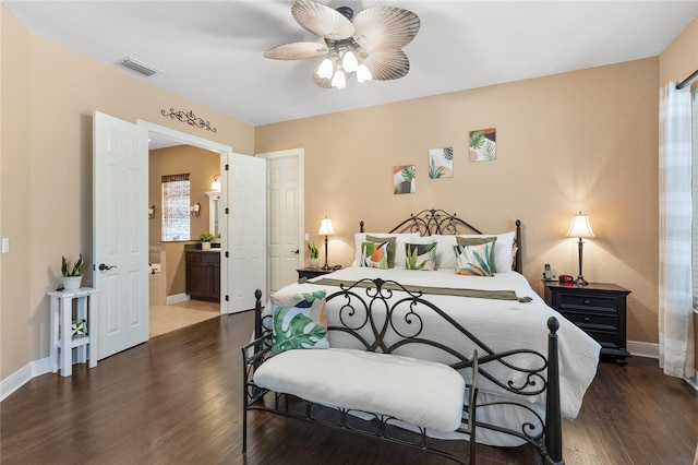 bedroom featuring ceiling fan, ensuite bathroom, and dark hardwood / wood-style flooring