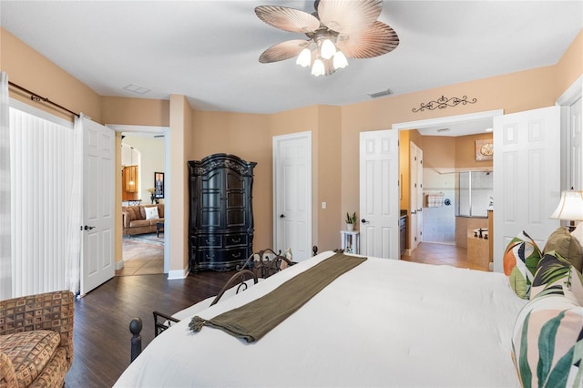 bedroom featuring ensuite bath, ceiling fan, and dark hardwood / wood-style floors