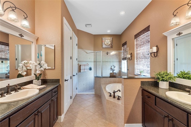 bathroom with independent shower and bath, vanity, and tile patterned flooring