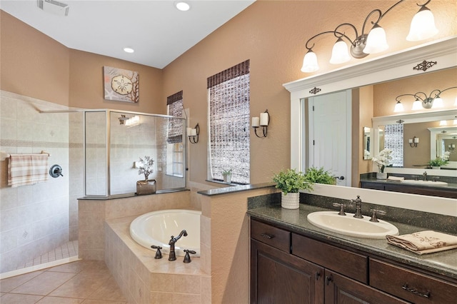 bathroom featuring tile patterned flooring, vanity, and separate shower and tub