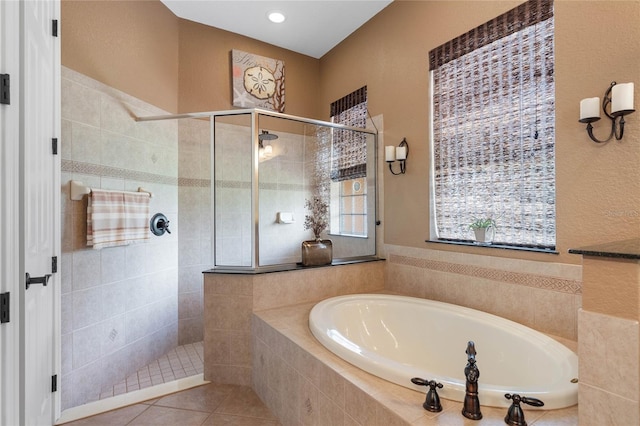 bathroom featuring shower with separate bathtub and tile patterned floors