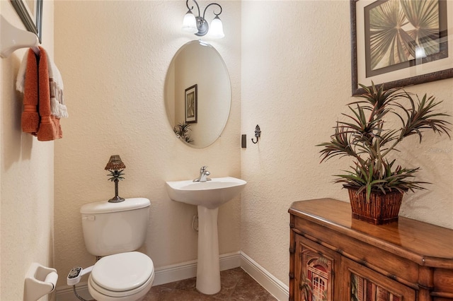 bathroom with toilet and tile patterned floors