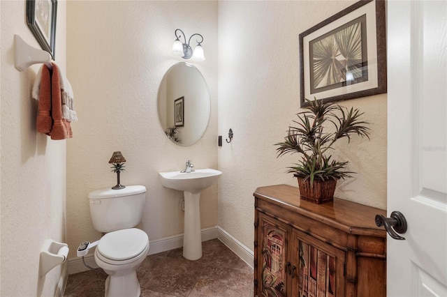 bathroom featuring tile patterned flooring and toilet