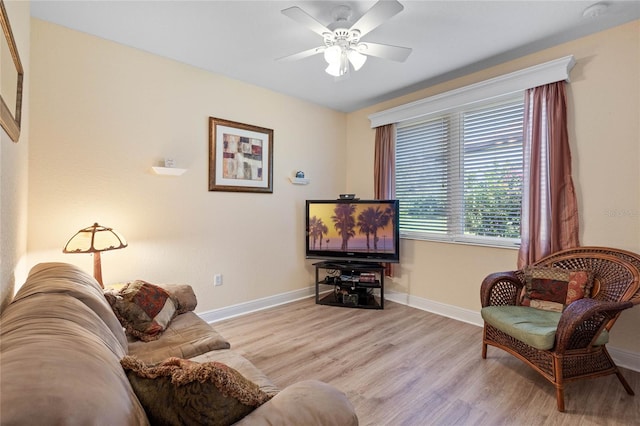 living room with light wood-type flooring and ceiling fan