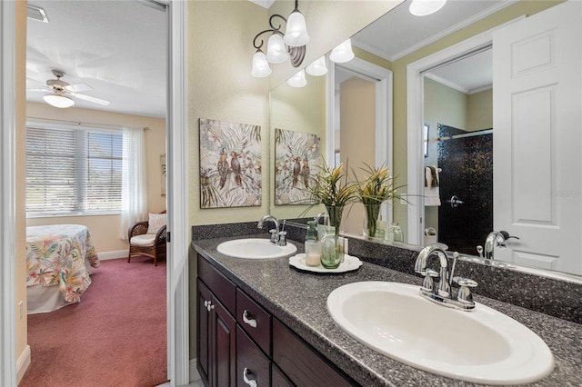 bathroom with walk in shower, vanity, crown molding, and ceiling fan