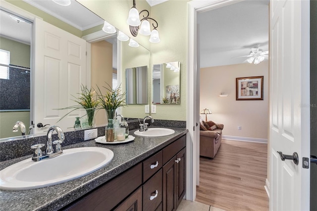 bathroom featuring hardwood / wood-style floors, ceiling fan, vanity, and crown molding