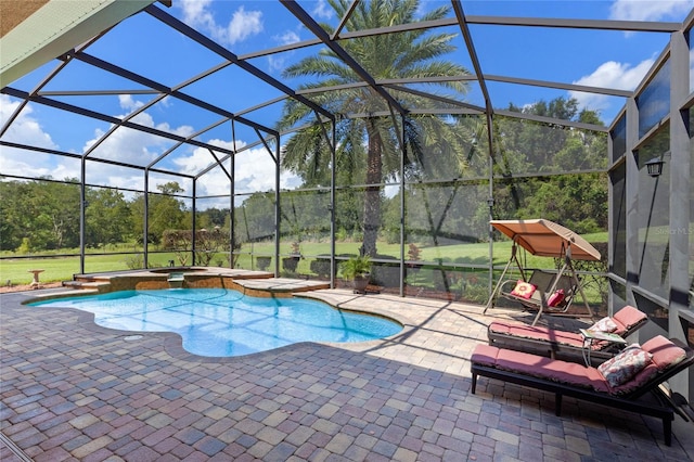 view of pool featuring a patio, an in ground hot tub, and a lanai