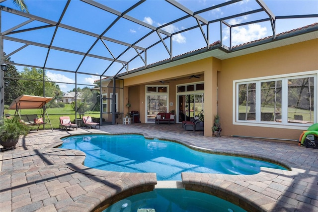 view of swimming pool featuring a lanai, a patio, and ceiling fan