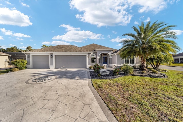 view of front of home featuring a front lawn and a garage