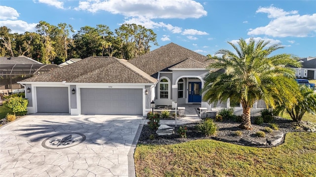 view of front facade with a garage, concrete driveway, roof with shingles, and stucco siding