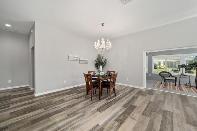 dining room with a chandelier and hardwood / wood-style flooring