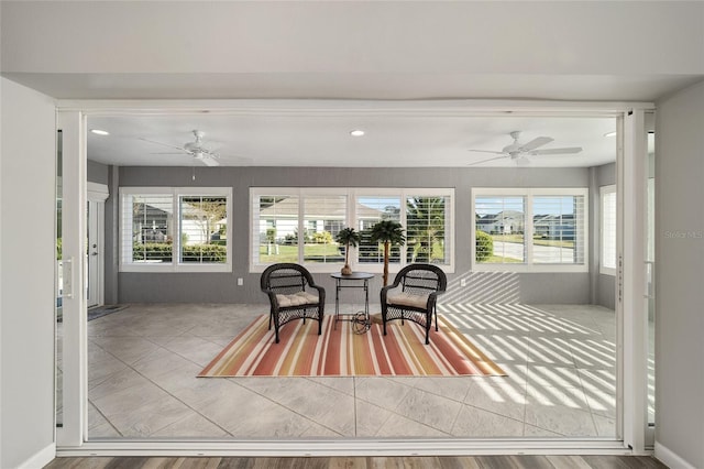 sunroom / solarium with ceiling fan