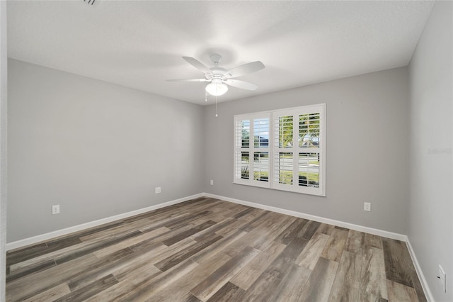 spare room with ceiling fan, hardwood / wood-style flooring, and a textured ceiling