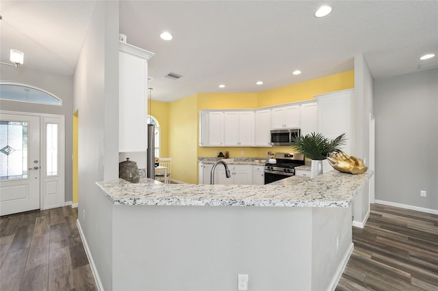 kitchen featuring kitchen peninsula, white cabinetry, stainless steel appliances, dark wood-type flooring, and light stone counters