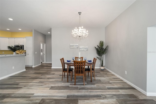 dining area with a chandelier and dark hardwood / wood-style floors