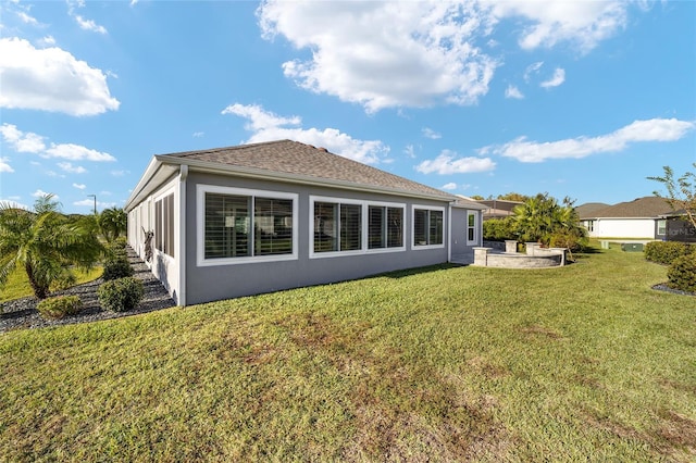 rear view of property featuring a patio area and a lawn