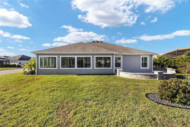 rear view of house featuring a yard and a patio