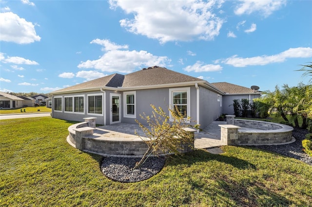 rear view of property featuring a patio and a lawn