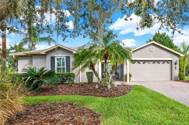 ranch-style home featuring a front lawn and a garage